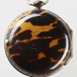 Pocket watch case covered with tortoise shell.