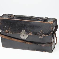 Dark brown (black faded?) leather camera carry case with strap. Metal clasp at front.