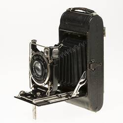 Front three quarter view of fold out black camera.