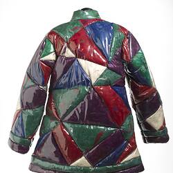 Back of quilted geometric plastic jacket filled with coloured feathers. The quilted sections are triangular.