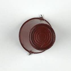 Underside of red toy bucket.