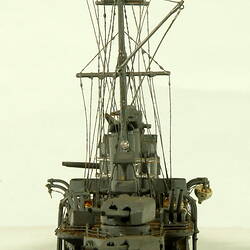 Naval ship with two masts, rear view.