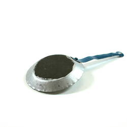 Toy silver frying pan, underside.