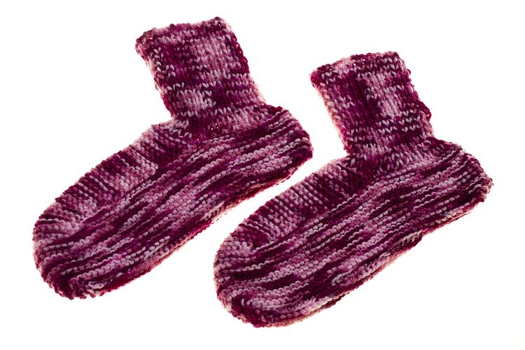 Second museum view of Ruby Tyler's variegated wool bed socks