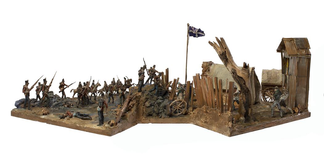 Model of figurines representing soldiers and miners engaged in fighting.