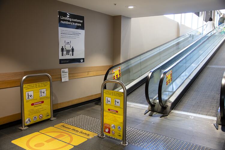 Signage Next to Escalator Outside Entrance to Woolworths, Blackburn South, 18 May 2020