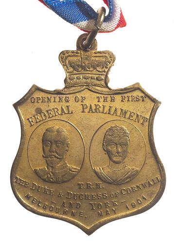 Shield shaped medal with portrait busts of Duke and Duchess of Cornwall and York.