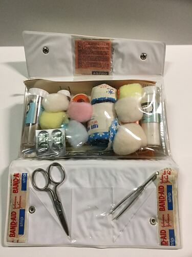 Open first aid kit showing contents.
