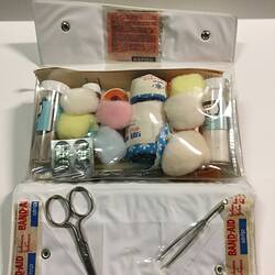 Open first aid kit showing contents.