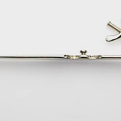 Long thin section of metal forceps.