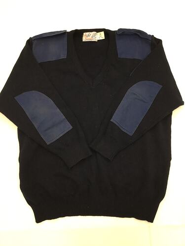 Navy blue wool blend jumper with navy cloth elbow patches and epaulettes.