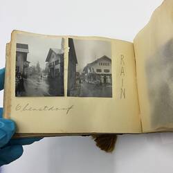 Two black and white photos glued on page of album with handwritten annotation in pencil beneath.