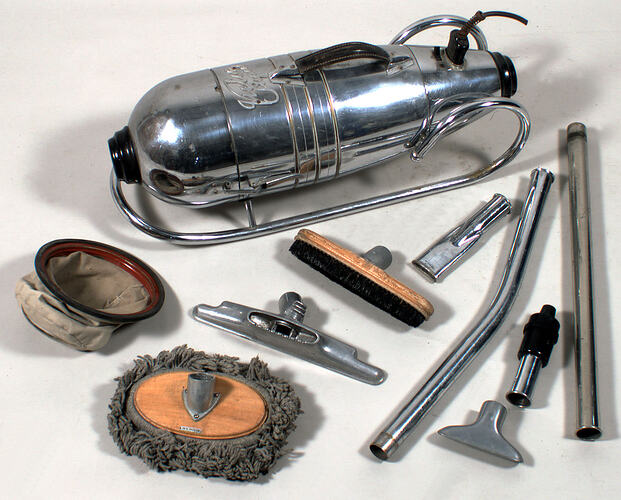 Silver metal vacuum cleaner canister with nozzle, brush and other parts.