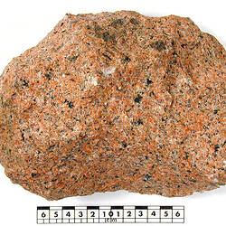 Red and black speckled piece of granite rock.