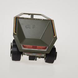 Plastic grey toy trailer with two wheels. Rear view.