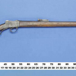 Side view of rifle with measure below.