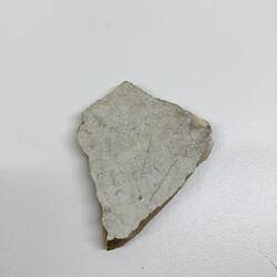 Fragment of white glazed earthenware plate base.