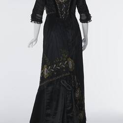 Black, silk satin dress, beading, floral embroidery. Back view.
