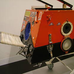Side view of painted iron lung.
