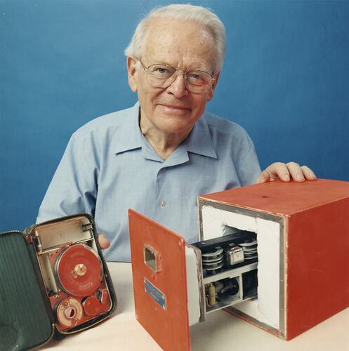 Man with flight recorder devices in black and brown boxes.