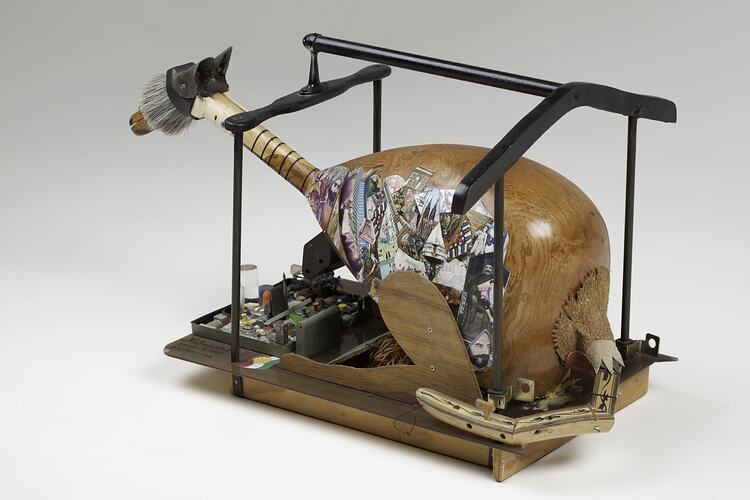 Left view of wooden and metal sculpture.
