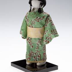 Front view of robed doll on mount.