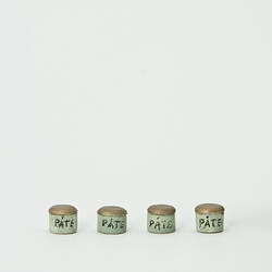Four small, gold topped pots, labelled 'Pate'.