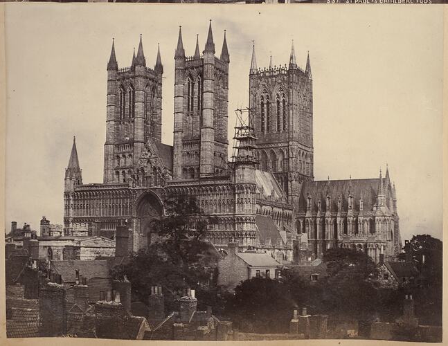 Cathedral with three towers. Trees in foreground.