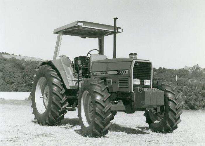 Front view of a tractor standing in a field.