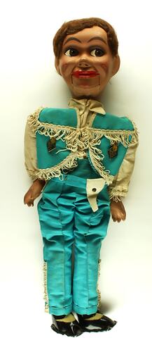 Ventriloquist doll in blue cowboy outfit.
