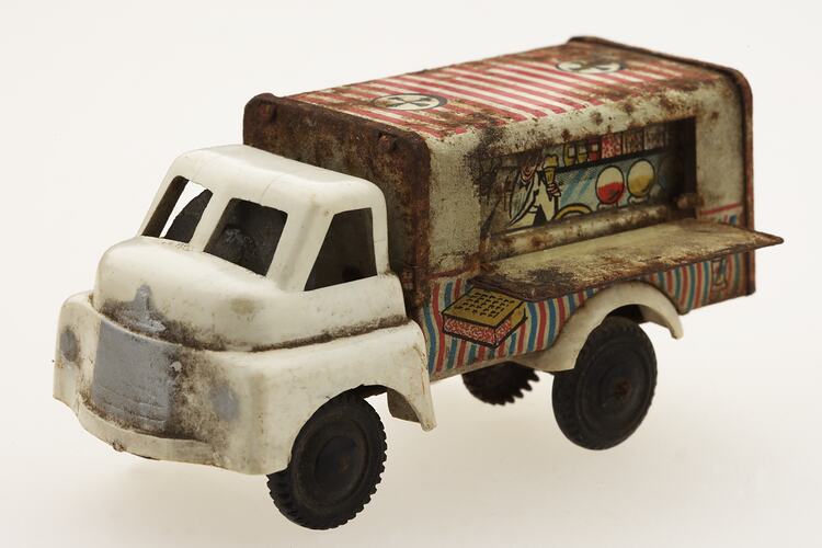 White toy ice-cream truck, front view.