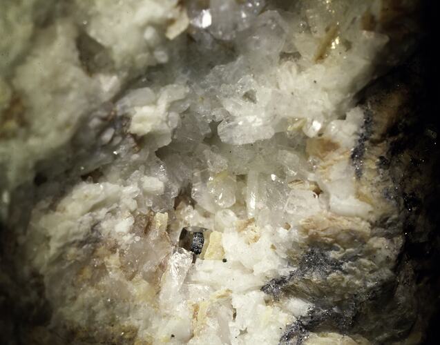 Blocky cream mineral infilling a cavity.