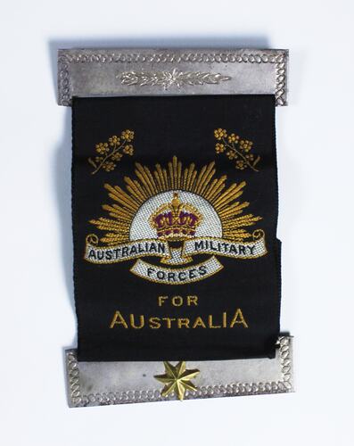 Black fabric parch with rising sun, crown, golden wattle motif and text, silver bars above and below patch.