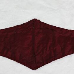 Inside of child's wide scalloped belt with maroon satin lining.