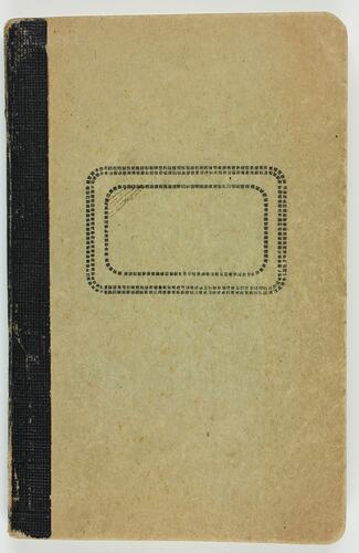 Cream cardboard covered notebook with black spine and rectangle in centre.