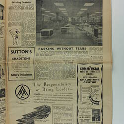 Back of newspaper with text and photo of store interior