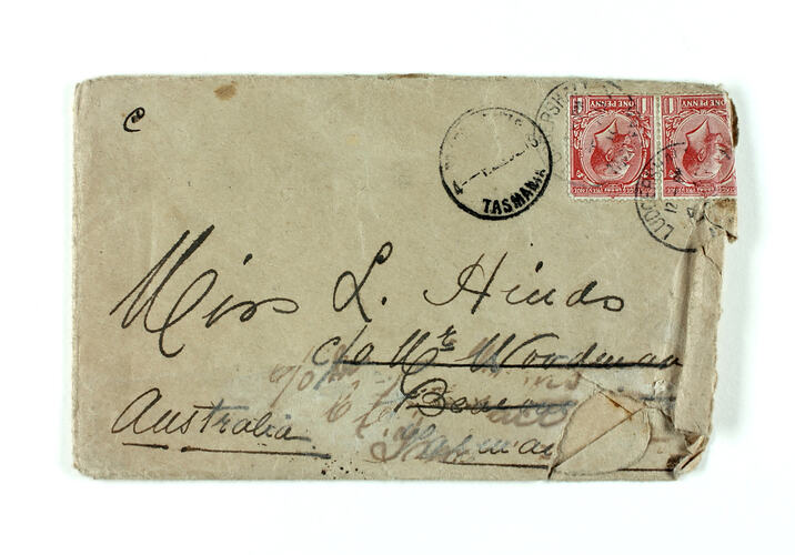 Front of hand-written envelope with red stamp.