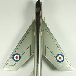 Silver model aeroplane. Blue, white and red rondels on wings and fuselage. Top view.