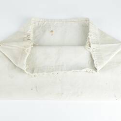 White rectangular canvas kit bag, folded and partially open.