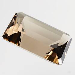 Rectangular, brown cut gem.