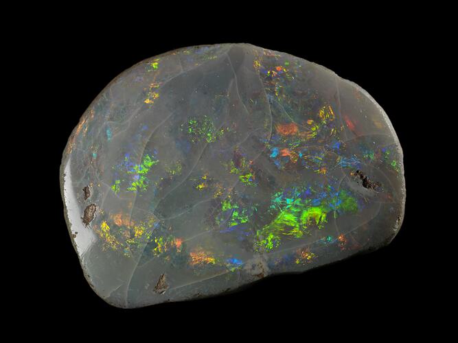 Iridescent rounded rock with greens, blues and yellows.
