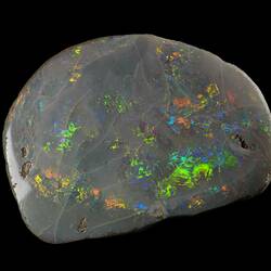 Iridescent rounded rock with greens, blues and yellows.
