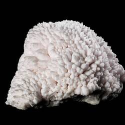 Pale pink mineral specimen.