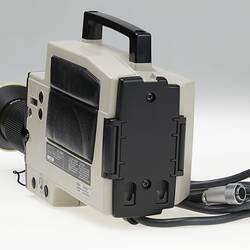 Rear view of black and beige video camera.