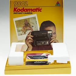 Yellow cardboard box with image of camera.