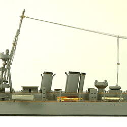 Naval ship with two masts, facing left.