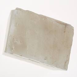 White, flat, sheet-like mineral.