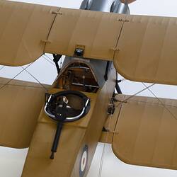 Model biplane aeroplane painted mustard brown. Top view detail of cockpit.