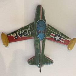 Toy green metal aeroplane with details in yellow, red and blue.