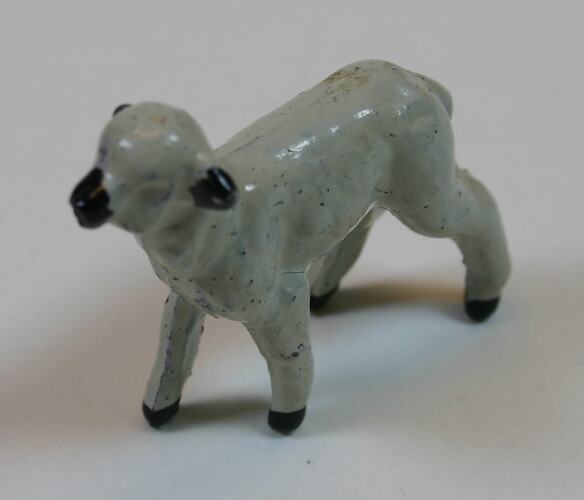 Toy metal white lamb with black face, ears and feet.